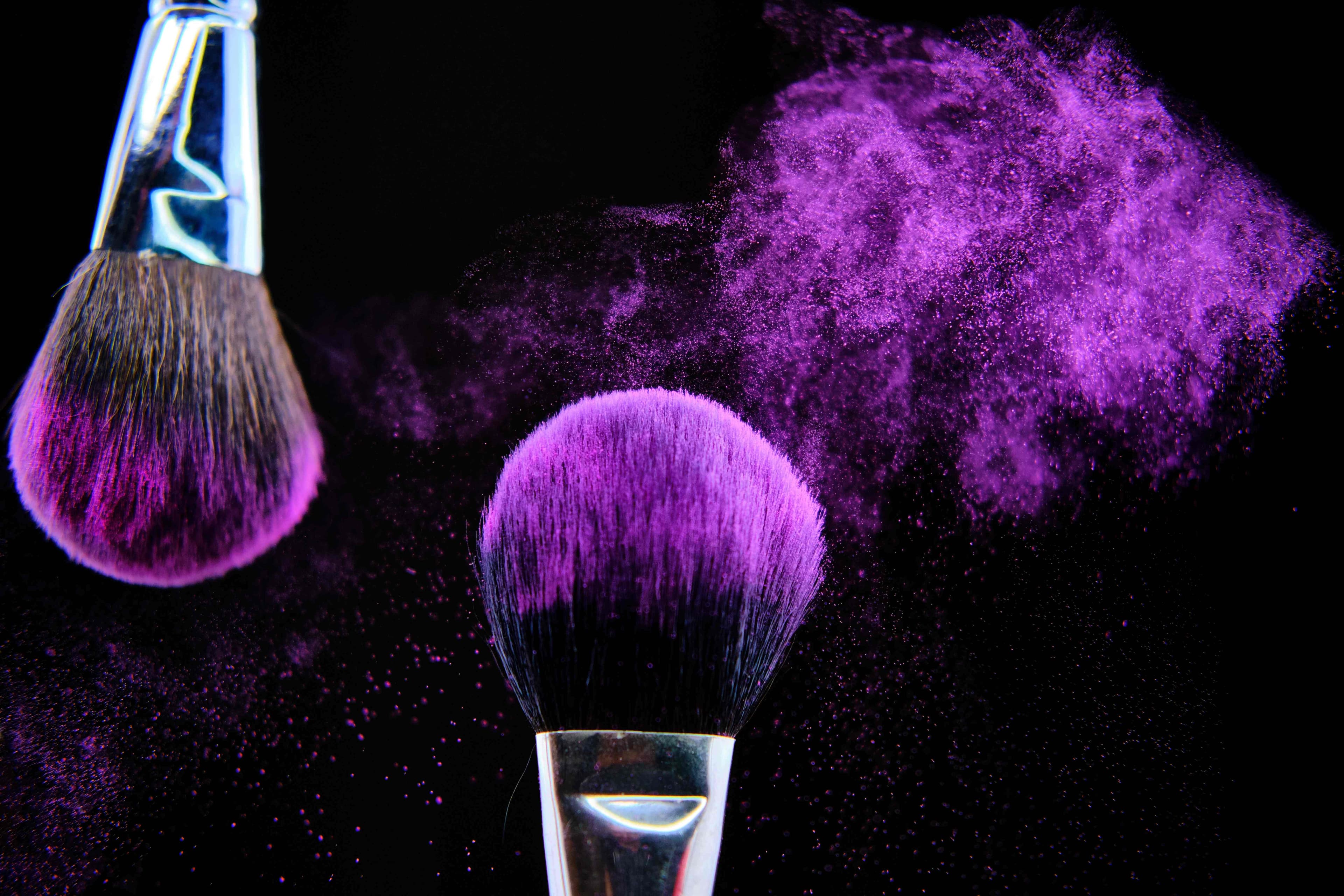 Makeup artistry with purple powder and brushes